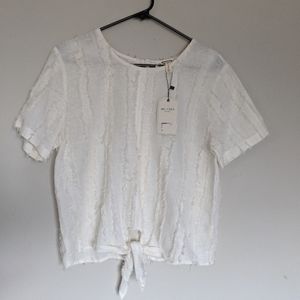 Anthropologie feathered cream top
